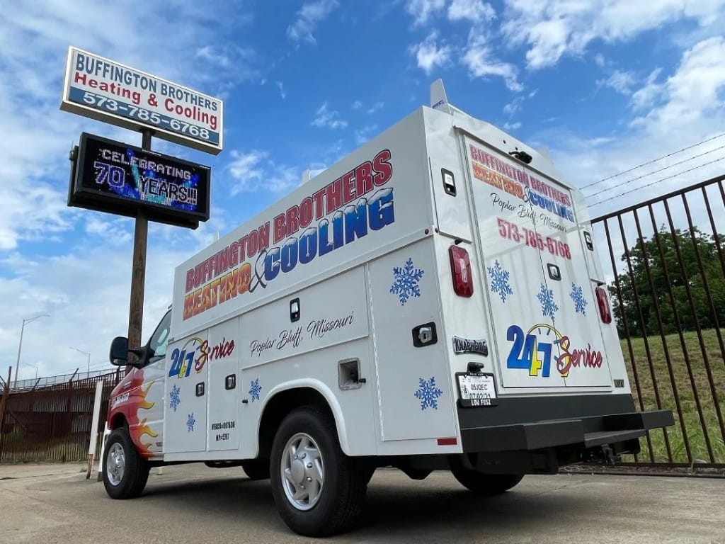Buffington Brothers service truck parked at the Poplar Bluff location with storefront signage and a digital board celebrating 70 years in business.